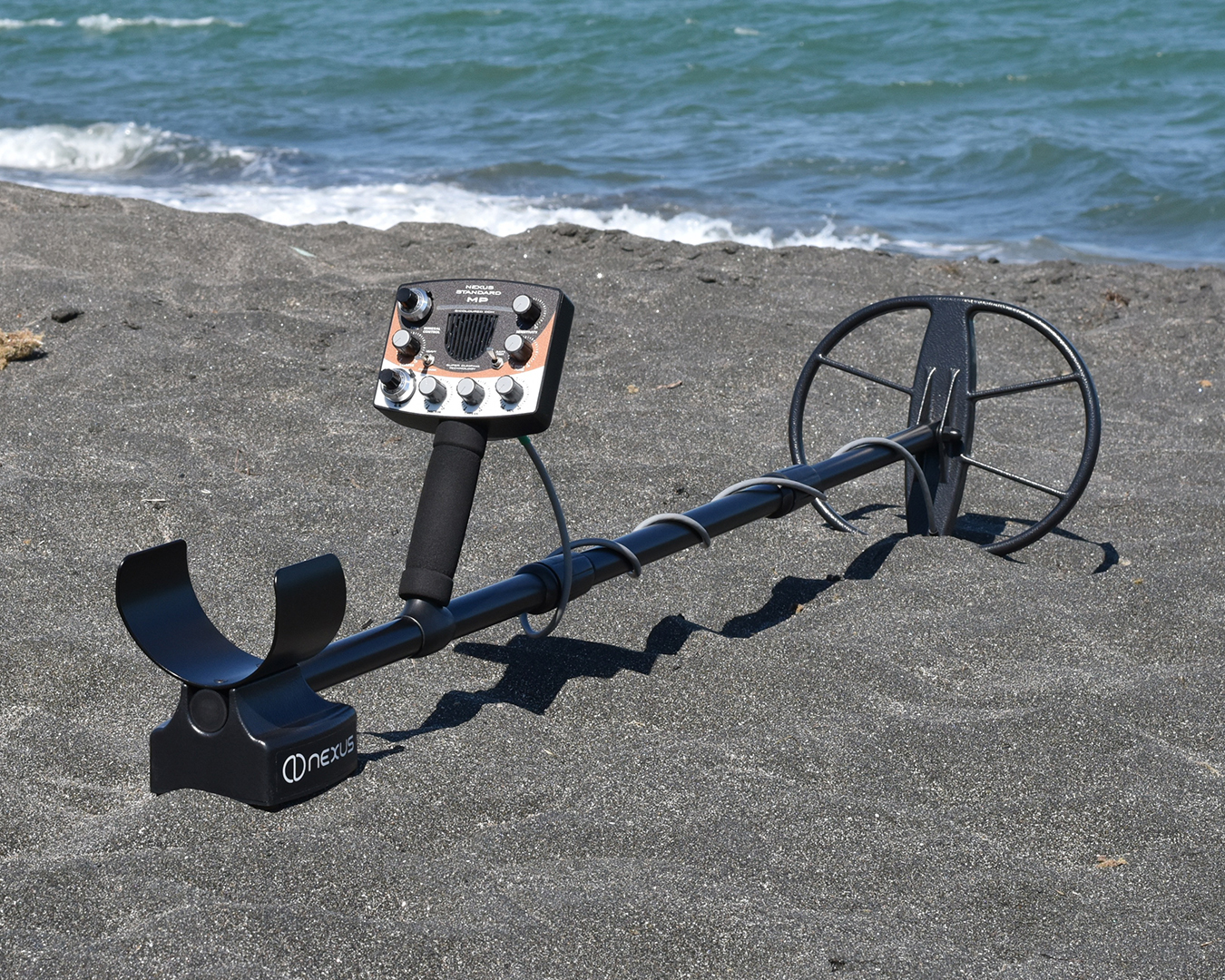 Analogue induction balance metal detector on the beach
